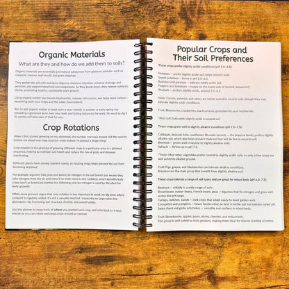 Open book on a wooden surface with text about organic materials and crop rotations.