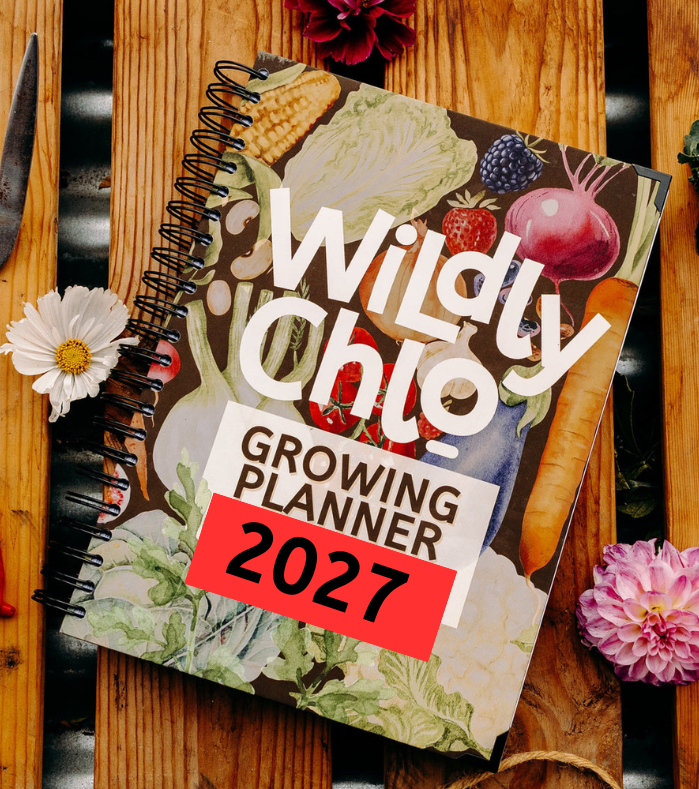 2027 Growing Planner with floral decorations on a wooden background